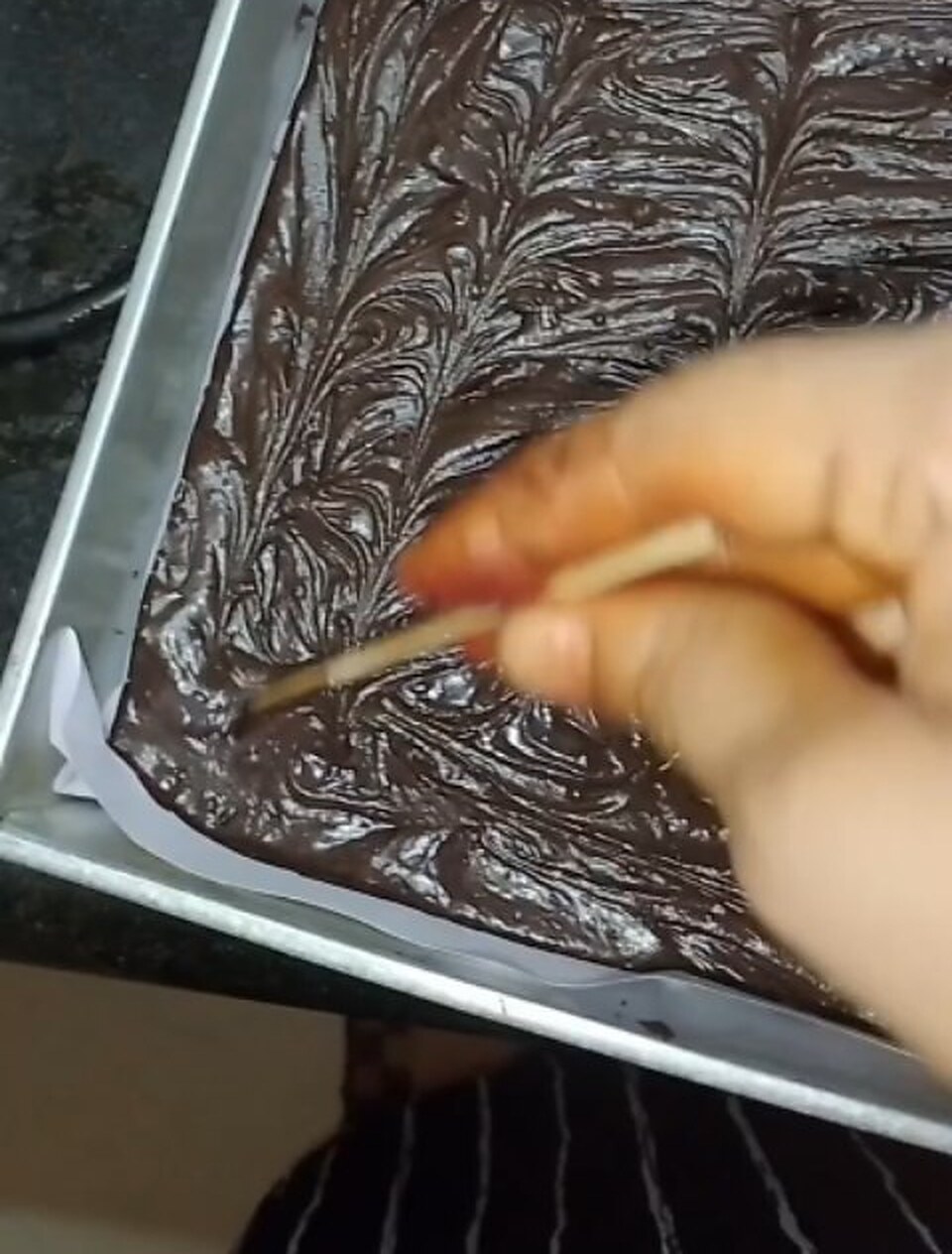 Hand-marbling a tray of Nutella brownie batter