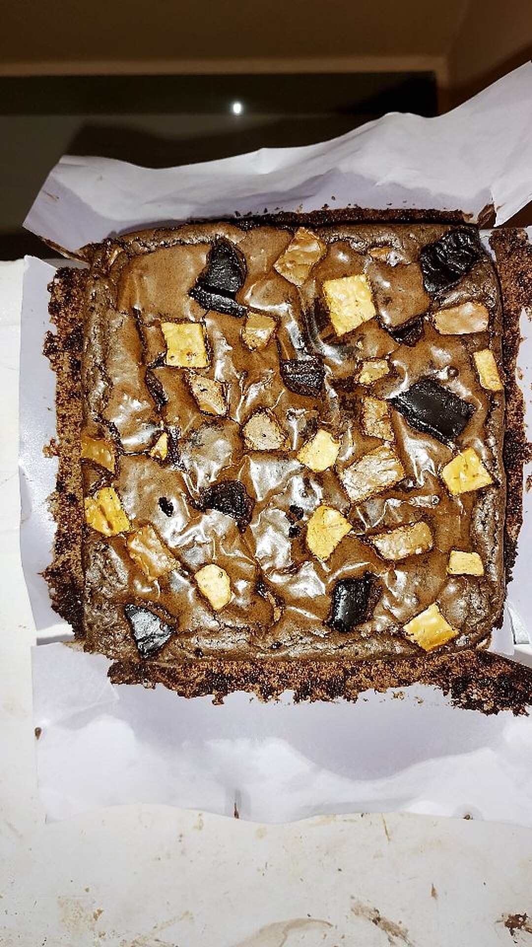 A customized brownie slab topped with chocolate chunks